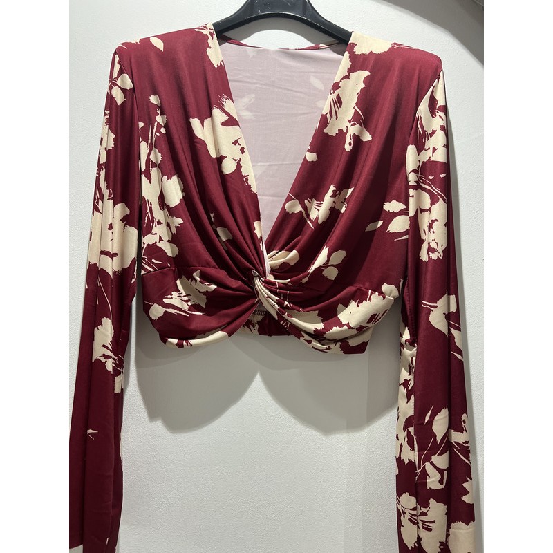 Blusa roja con estampado floral en blanco.