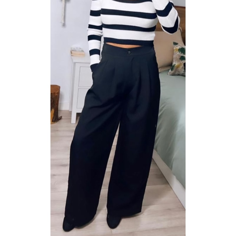 Pantalón negro de vestir ancho, con bolsillos, visto por delante.